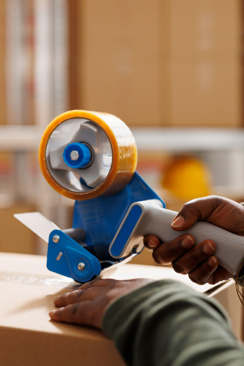 Dispensador de cinta adhesiva en acción en un almacén